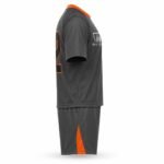 Custom lacrosse uniform side view — grey and orange sublimated jersey with shorts, Wani Wear