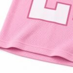 Close-up of sublimated white number print on pink mesh football jersey fabric