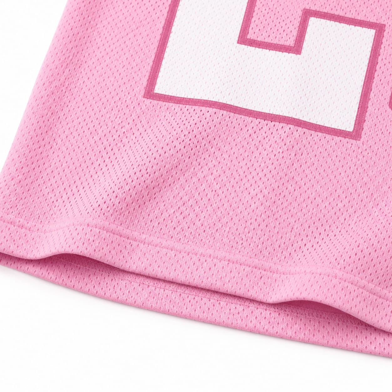 Close-up of sublimated white number print on pink mesh football jersey fabric