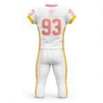 Back view of white, pink, and gold custom American football uniform with sublimated number 93 and WANI WEARS logo