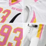 Close-up of custom American football uniform showing pink and gold V-neck collar, sublimated side stripe, number 93, and pant waist closure