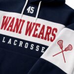 Close-up of embroidered lacrosse stick crest and Wani Wears chest print on hoodie