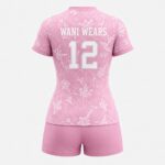 Back view of custom pink women’s volleyball uniform with team name and number 12