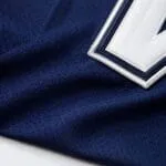 Breathable navy performance fabric and white tackle-twill number close-up