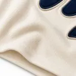 Cream performance fabric close-up on custom full button baseball jersey