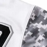 Custom baseball jersey breathable mesh fabric and reinforced sleeve stitching close-up