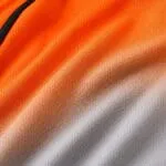 Orange gradient sublimated baseball jersey fabric close-up