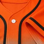 Custom orange baseball jersey collar, button and stitching close-up
