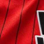 Breathable red polyester fabric close-up on a custom sublimated baseball jersey