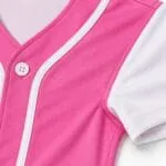 Pink baseball jersey collar, piping, button and reinforced stitching close-up