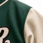 Breathable green and cream mesh baseball jersey fabric close-up