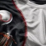 Custom baseball T-shirt fabric close-up showing breathable mesh texture, detailed ball graphic and red seam print