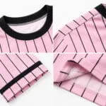 Custom pink pinstripe baseball T-shirt stitching close-up showing black ribbed collar, shoulder seam, sleeve trim and bottom hem