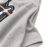 Custom baseball tournament T-shirt fabric close-up showing soft grey material, durable sleeve stitching and detailed print