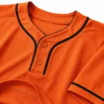 Custom orange two-button baseball jersey collar with black piping and reinforced stitching