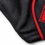 Black baseball jersey breathable mesh fabric and reinforced hem stitching close-up