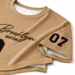 an oversized baseball T-shirt stitching close-up showing crew neck, short sleeve, side split and printed number