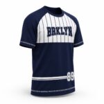 Navy blue and white custom baseball jersey side view with player number and raglan sleeves