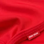 Red performance fabric close-up for baseball pants