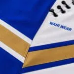 Custom baseball pants fabric stitching and eyelets close-up