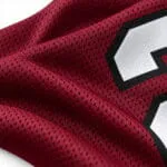 Breathable burgundy mesh football jersey fabric close-up