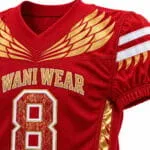 Red and gold custom American football uniform fabric and stitching close-up