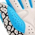 Close-up of elephant print batting gloves showing blue leather binding and perforated thumb