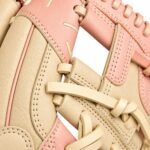 Close-up of kip leather finger channels with pink piping and contrast stitching on a baseball glove