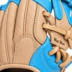 Close-up of reinforced stitching and leather lacing on a tan and sky-blue kip leather baseball glove