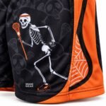 Close-up of reinforced hem and panel stitching on custom lacrosse shorts with skeleton print