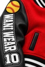 Side view of red custom varsity jacket with black sleeve, sleeve lettering and striped rib-knit cuff