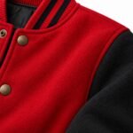 Close-up of textured red body fabric next to matte black sleeve fabric on a custom varsity jacket