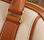 Custom canvas duffle bags with cognac leather trim, gold hardware and luggage tag