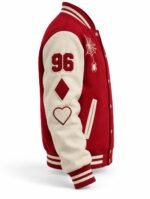 Side view of a red varsity jacket with cream sleeve, "96" number, diamond and heart patches, striped rib cuffs and snap front