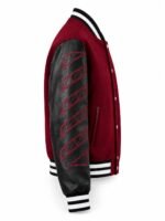 Side view of leather sleeve letterman jacket with embroidered diagonal stripe design and silver snap buttons
