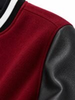 Close-up of burgundy wool body and black pebble-grain leather sleeve on private label varsity jacket