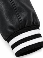 Black leather sleeve with black and white striped rib-knit cuff on wholesale varsity jacket