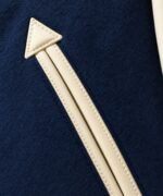 Arrow-tip leather welt pocket detail on wool varsity baseball jacket