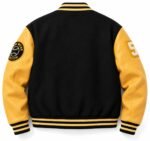 Back of black and gold varsity jacket with leather sleeves, chenille number and baseball patch