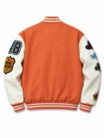 Back of orange custom varsity jacket with white leather sleeves, chenille number and embroidered sleeve patches