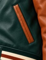Tan leather-piped welt pocket on green leather varsity jacket
