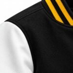 Black wool body, white leather sleeve and black and gold striped collar detail