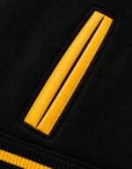 Yellow leather-piped welt pocket on black wool baseball varsity jacket
