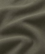 Olive green matte bomber jacket fabric close-up, wholesale jacket supplier