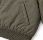 Welt hand pocket and ribbed hem on custom olive green bomber jacket by Wani Wear