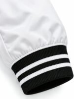 Close-up of black and white striped rib-knit cuff on custom bomber jacket