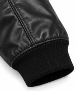 Ribbed knit cuff and piped sleeve seam on black leather bomber jacket, OEM manufacturer