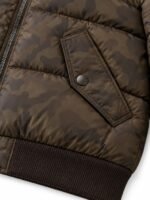 Close-up of angled snap flap pocket and rib knit hem on camo puffer bomber jacket