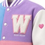 Chenille letter patch and embroidered logo on custom varsity jacket with heart sleeve embroidery