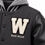 Close-up of chenille patch and embroidered logo on custom varsity jacket by Wani Wear
